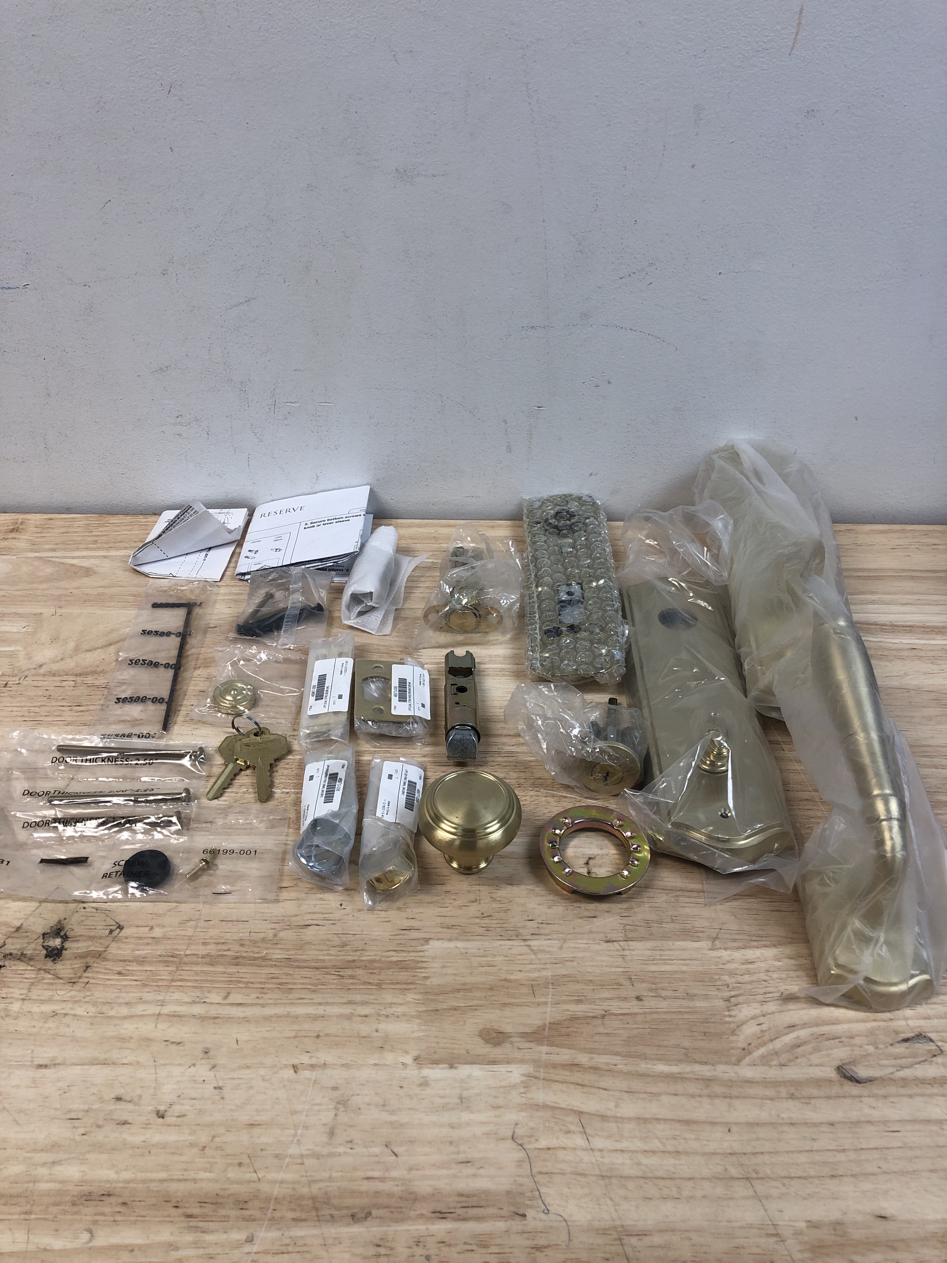 Actual inventory photograph: Baldwin EENEWxTRATAE044 New Hampshire One Piece Single Cylinder Keyed Entry Handleset with Interior Traditional Knob and Emergency Egress Function - Lifetime Satin Brass
