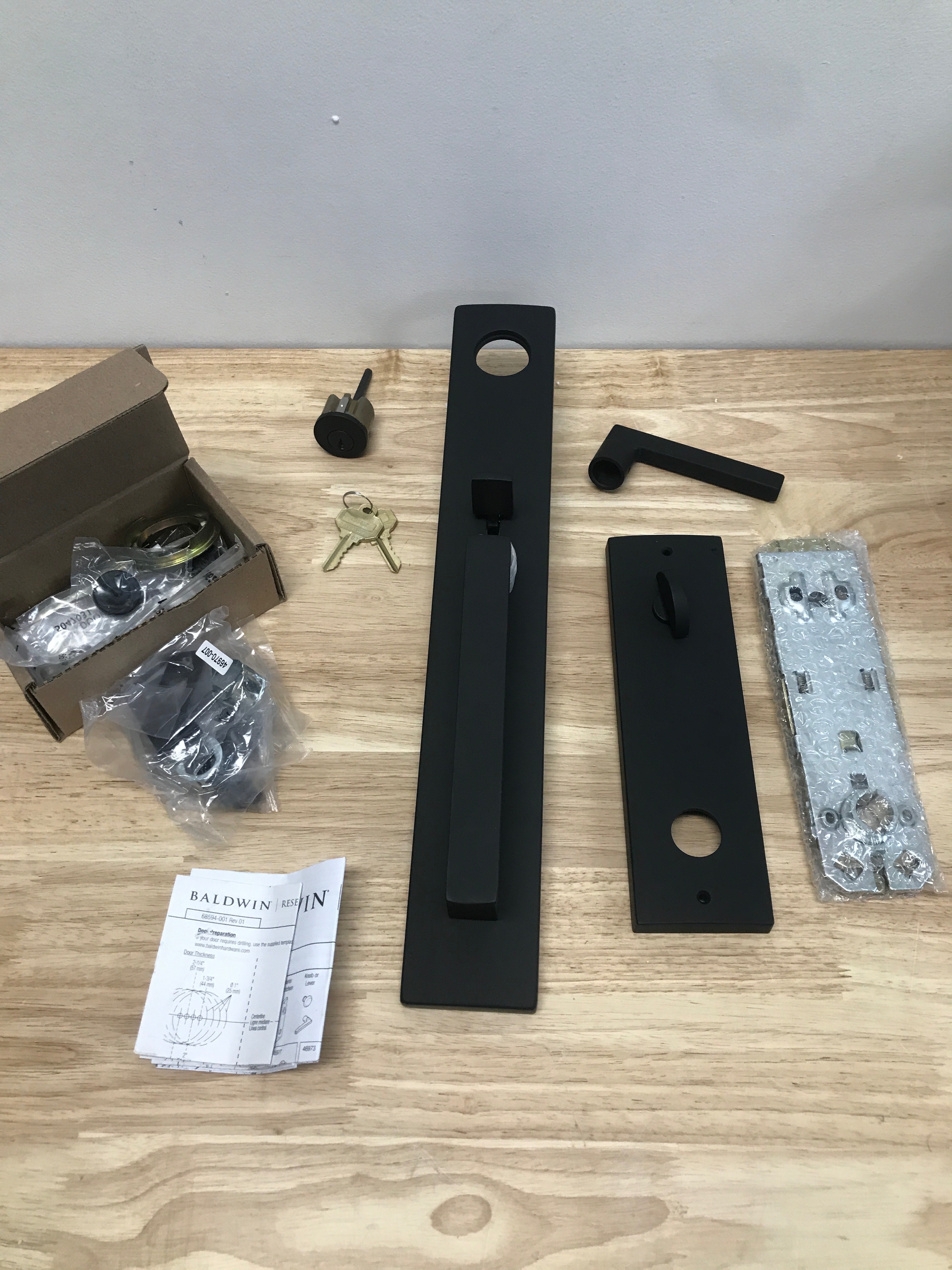 Actual inventory photograph: Baldwin EESANxSQUCQE190 Santa Cruz Full Plate Single Cylinder Keyed Entry Handleset with Interior Square Lever and Emergency Egress Function - Satin Black