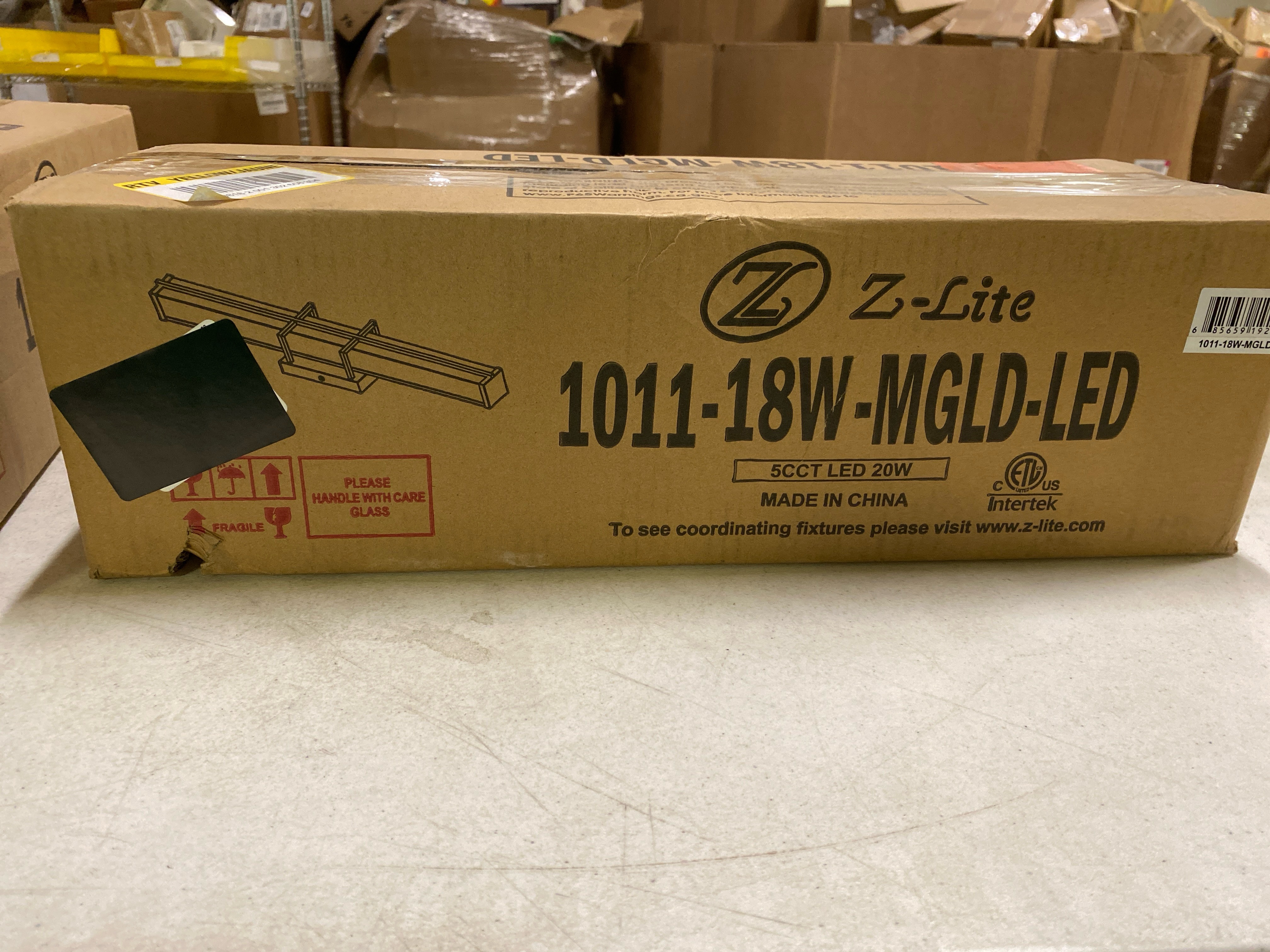 Actual inventory photograph: Unbranded 1011-18W-MGLD-LED Harrison 18 in. Modern Gold Integrated LED Vanity Light with Frosted Plastic Shade